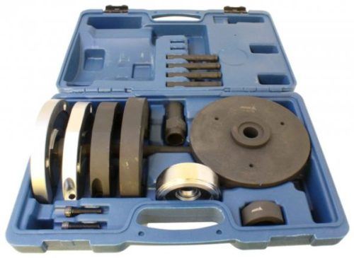 Top view of open blue case showing stacked metal driver rings, large black press plate, silver adapter and bolts in molded compartments