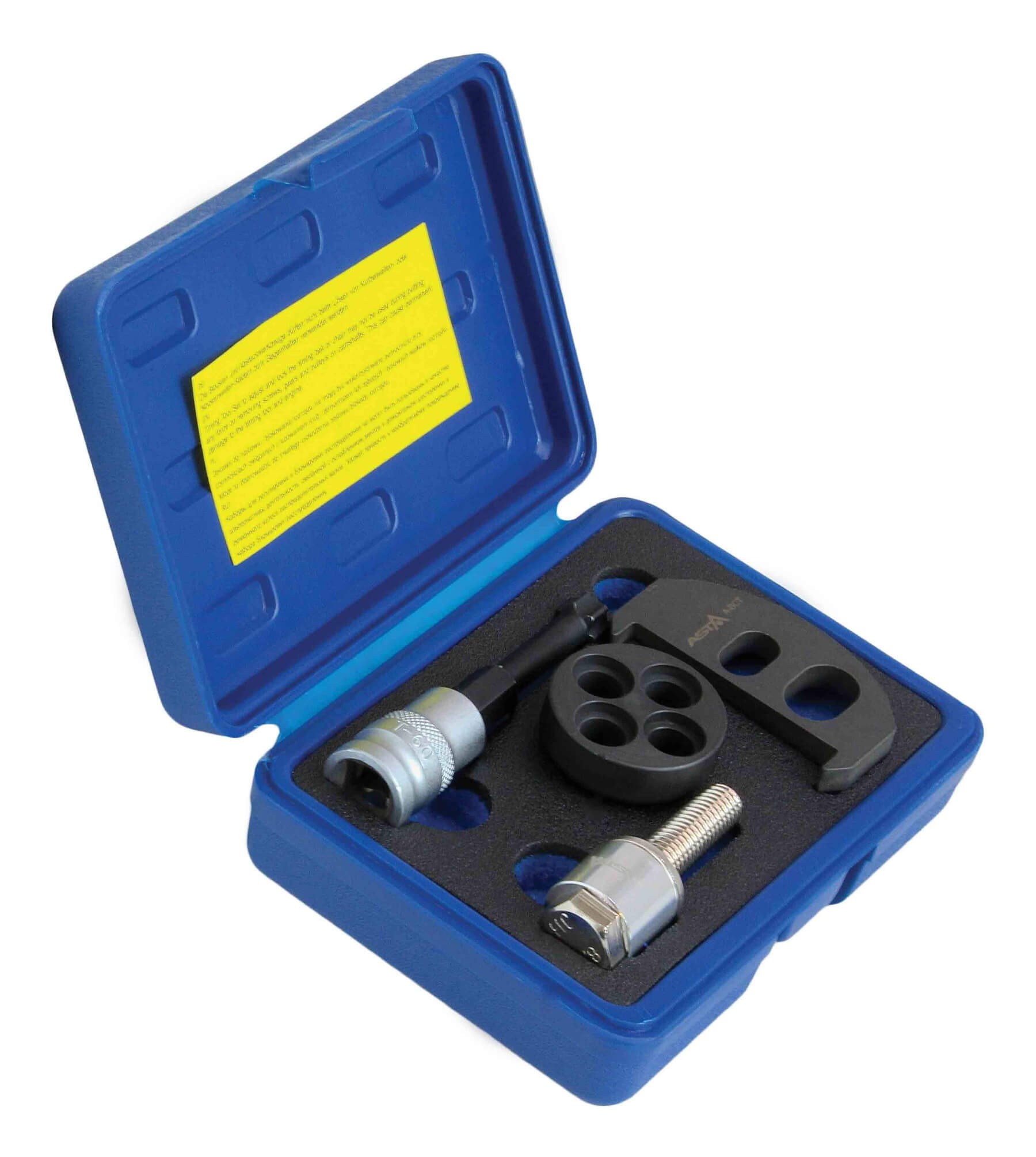 Angled view of blue carrying case showing crankshaft fixing tools: adapter, threaded bolt, round spacer, C-shaped bracket and yellow instruction label.
